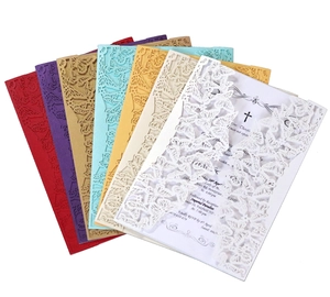 Macro view of laser-cut butterfly invitation cards in various colors for weddings