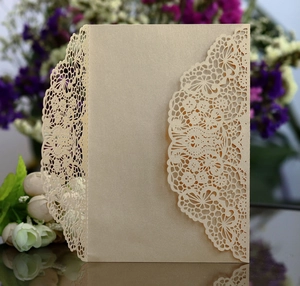 Detailed laser-cut champagne gold lace invitation with elegant floral hollow patterns