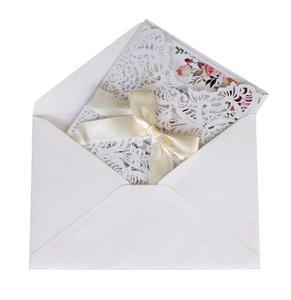 Elegant white laser cut wedding invitations with floral lace shell and satin ribbon bow