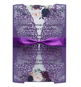 Detailed laser-cut purple lace wedding invitation with ribbon and floral insert card