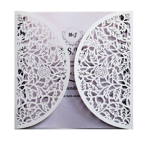Laser cut white floral wedding invitation with a light purple pearlescent inner card