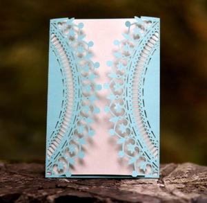 Detailed laser-cut floral pattern on light blue pearlescent paper invitation cover