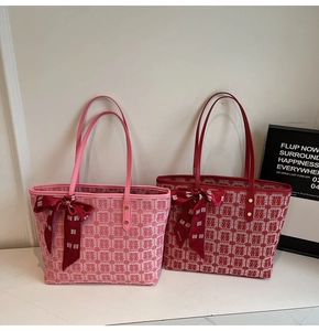 Detail of red and pink festive tote bags with traditional double happiness patterns