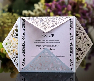 Elegant laser-cut butterfly wedding invitation with white hollow cover and pink inner card