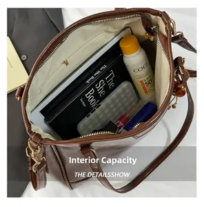 Internal capacity of the dark brown tote bag showing main space and zipper pocket