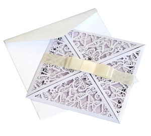 Elegant laser-cut white butterfly invitation set with pink card and cream satin ribbon