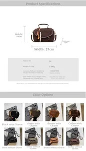 Detail of vintage suede-textured crossbody bag with matte metal clasp and beaded charm
