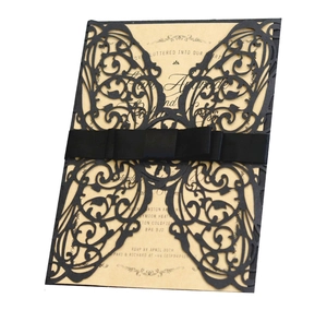 Elegant black laser-cut butterfly invitation set with silk ribbon and cream inner card