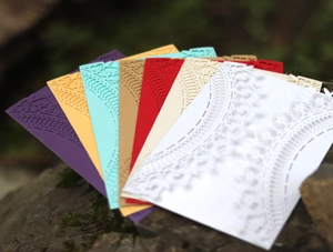Detailed laser-cut hollow lace edges on premium wedding invitation envelopes in multi-colors