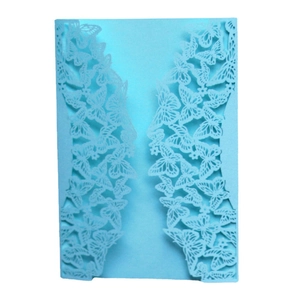 Detail view of light blue laser-cut butterfly invitation cover with intricate hollow pattern