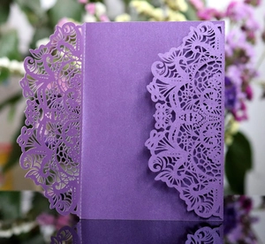 Detail of laser-cut lace pattern on elegant purple wedding invitation card cover