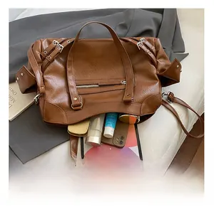 Interior view showing the large capacity for tablet, phone and cosmetics in the brown tote bag