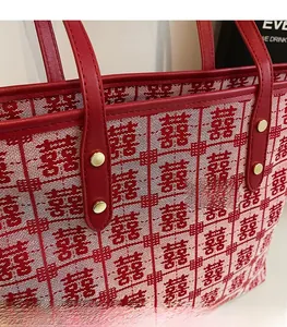 Detail of red jacquard canvas tote bag with traditional Chinese Double Happiness patterns