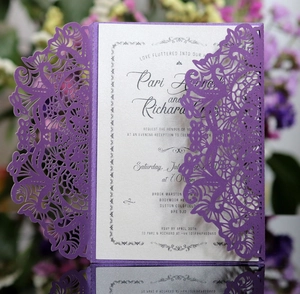 Detailed laser cut floral wedding invitation with elegant purple sleeve and silver insert