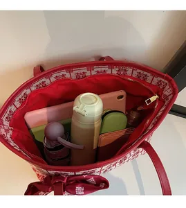 Top view of red tote bag with囍pattern showing large interior capacity with daily items