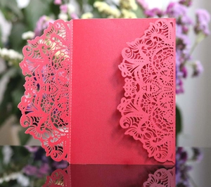 Detailed laser-cut dark red wedding invitation card with intricate floral patterns