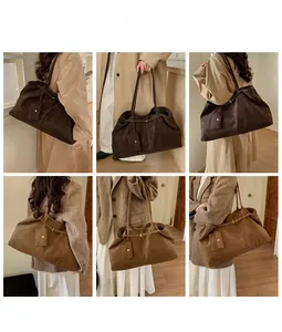 Detail view of large suede tote bag in dark coffee and khaki showing spacious capacity
