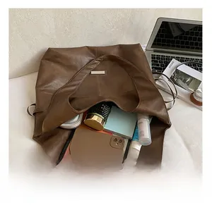 Interior view of the dark brown oil wax leather tote bag showing large storage capacity
