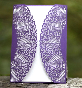 Deep purple laser-cut wedding invitation featuring intricate lace patterns and leaf textures