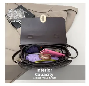 Interior view of brown quilted bag showing storage for umbrella and wallet