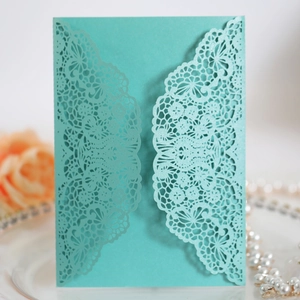 Elegant mint green laser cut wedding invitation card with intricate lace floral patterns