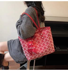 Detail of red and white woven tote bag featuring festive double happiness jacquard patterns