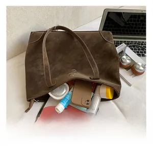 Detail view of large capacity dark brown suede tote bag showing internal storage space