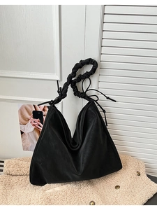Detailed close-up of a black matte PU leather hobo bag featuring a ruffled cloud-style strap