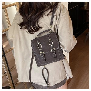 Retro vintage dark brown leather backpack for women shown in a casual lifestyle setting