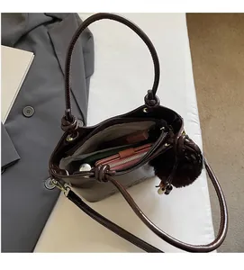 Interior view of brown patent leather bucket bag showing large capacity with pockets