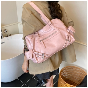 Detail view of the large pink vintage tote bag with side pockets and a wide shoulder strap