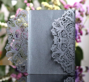 Detailed laser-cut floral pattern on shimmering grey wedding invitation card