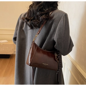 Detail of vintage oil wax leather shoulder bag in dark coffee with adjustable strap
