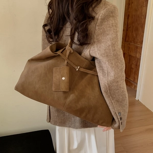Detail of vintage brown suede tote bag with small side pouch and pleated opening