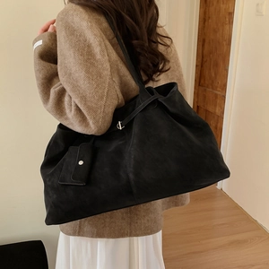 Large black matte tote bag with matching mini coin purse detail on a shoulder strap