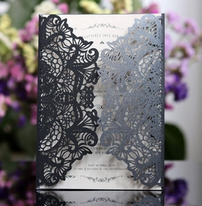 Close-up of laser-cut mandala hollow pattern on navy blue pearlescent wedding invitation