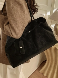 Chic black large capacity tote bag in matte finish with a matching small coin purse charm