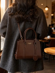 Dark brown vintage faux leather tote bag with gold logo and crossbody strap