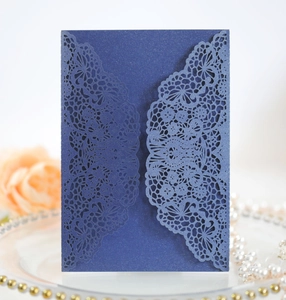 Detailed laser-cut lace floral pattern on elegant navy blue pearlescent wedding invitation