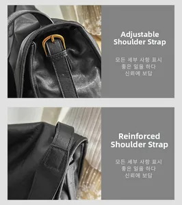Detail of adjustable leather strap with gold buckle and reinforced stitching on black tote