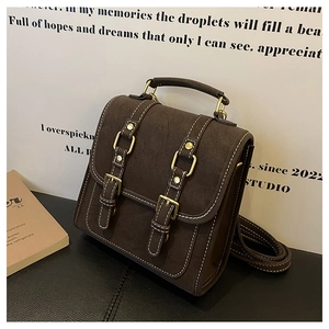 Detail of dark brown vintage backpack with suede texture and contrast stitching details