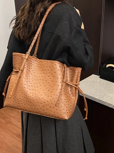 Brown ostrich embossed leather tote bag with gold hardware and drawstring detail