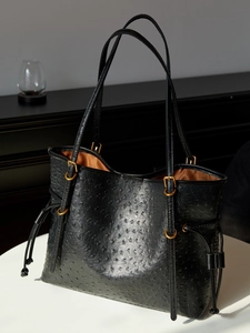 Large black ostrich-patterned tote bag with gold buckles and drawstring for women