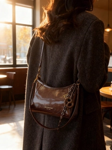 Vintage brown wax oil leather shoulder bag with glossy finish and retro lettering