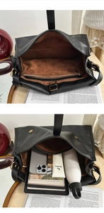 Detail view of large black leather messenger bag showing spacious interior and zipper pocket