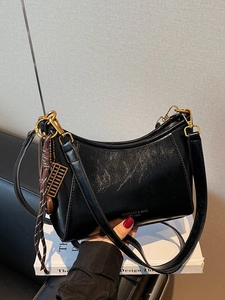 Retro black wax leather crescent shoulder bag with golden hardware and charm on book
