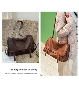Detail of vintage brown leather messenger bag with flap closure and twin decorative straps