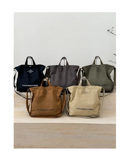 Canvas tote bags in multiple colors showing crossbody straps and logo print details
