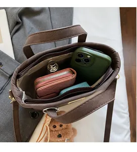 Top view of brown tote bag interior showing spacious compartments and accessories