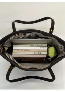 Top view of large brown tote bag showing spacious interior with striped lining and essentials